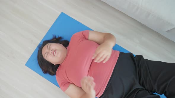 Attractive oversize big chubby girl fight to lose weight exercise in living room for health care.