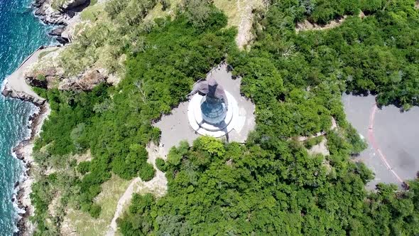 A birds eye view of the popular tourism landmark Cristo Rei statue and surrounding greenery and rugg