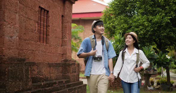 Couple hand together while visiting at ancient temple