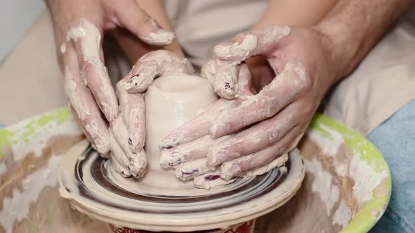 Couple Hands Making a Pot on a Pottery Workshop