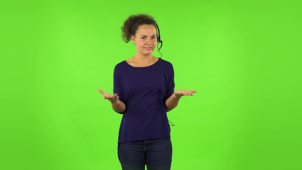 Curly Woman Talking on Headphones, Call Center. Green Screen