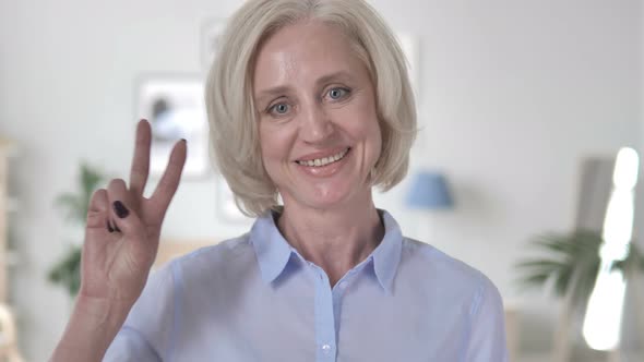 Victory Sign by Positive Aged Woman
