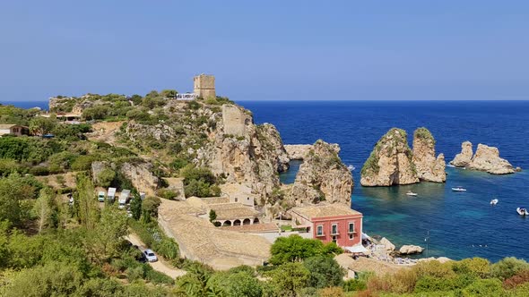 Panorama of beautiful stacks or Faraglioni of Scopello with Tonnara tuna factory and Torre Doria tow