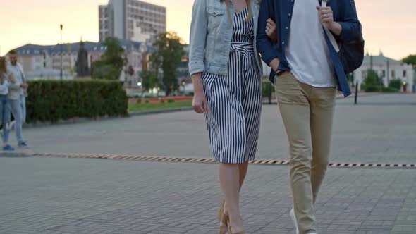 Boyfriend and Girlfriend Walking along Street