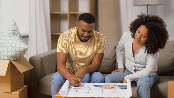 Couple with Blueprint and Color Palettes at Home