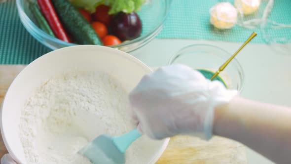 The Chef Mixes the Tortilla Ingredients with a Spoon