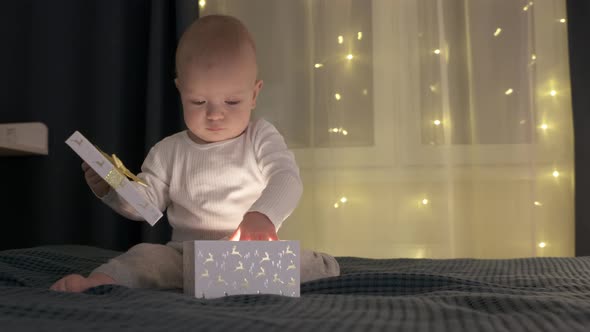 Happy Little Child Open the Box with Christmas or Birthday Present Kid Receiving Gift in Decorated