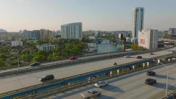 Forwards Fly Above Busy Multilane Highway in City