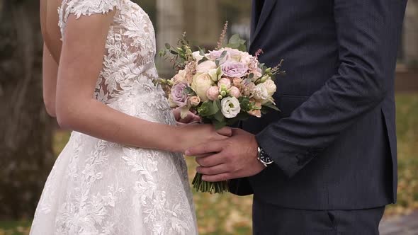 Wedding Walk, Close-up of a Bride and Groom Holding Hands