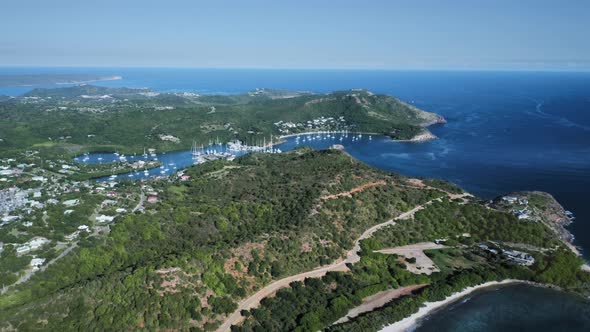 Drone view an island hill with a city and the bay with white yachts in Antigua and Barbuda