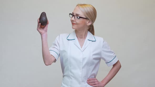 Nutritionist Doctor Healthy Lifestyle Concept - Holding Organic Avocado