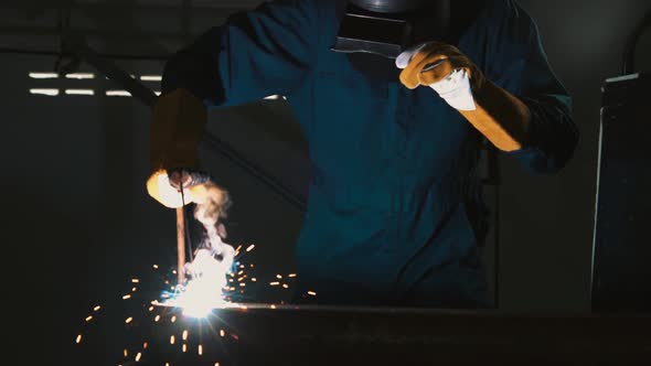 Metal Welder Working with Arc Welding Machine