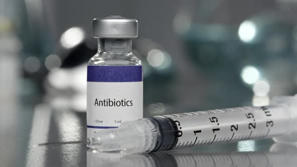 Antibiotics vial with syringe placed next to it