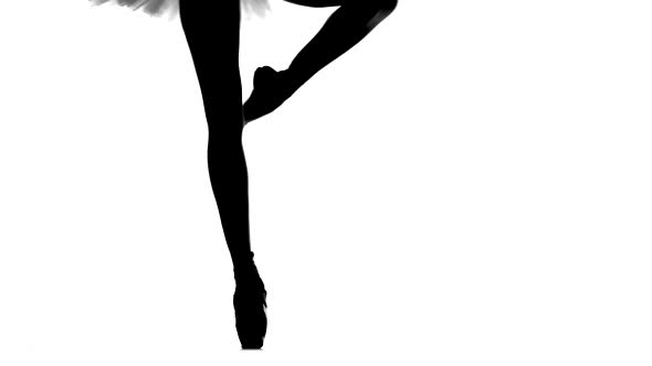 Young Ballerina Dancing, Closeup on Legs and Shoes, Standing in Pointe Position