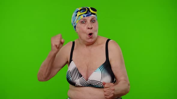 Mature Woman Swimmer in Swimsuit Showing Negative Emotions Hate Rage Upset Stress on Chroma Key