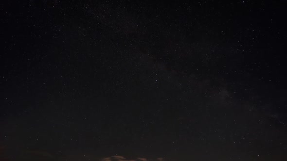 Moonrise on a night sky with stars in algae clouds