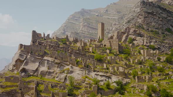 Ruins of ancient city on rocks on sunny day