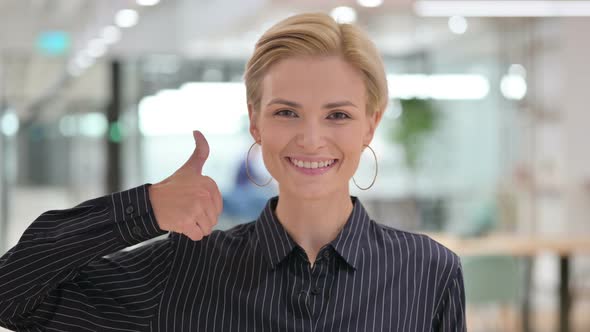 Positive Young Businesswoman Doing Thumbs Up Sign