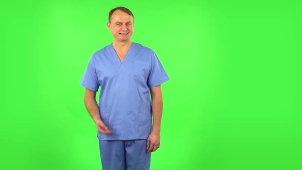 Medical Man Shrugs and Shakes Her Head Negatively, Green Screen