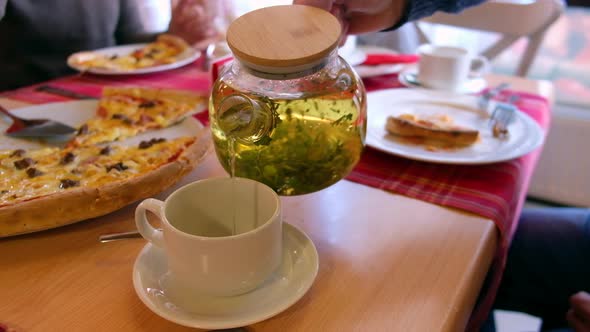 Man Pours Tea to Cup