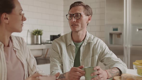 Caucasian Spouses Talking over Breakfast