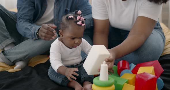 Parents and Toddler Daughter Having Fun Playing at Home