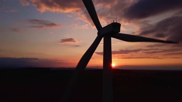 Silhouette of Windmill Turbine in Field at Sunset Sky