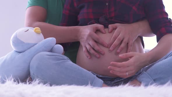 Mom and Dad Hands on Pregnant Tummy. Pregnant Couple Caressing Pregnant Belly