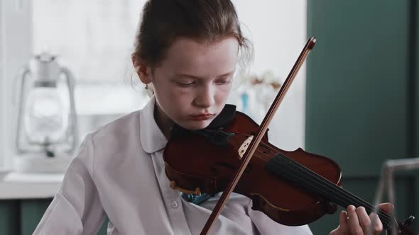 Tired Girl Playing Violin During Lesson