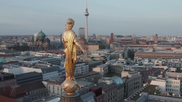 AERIAL: Golden Statue Close Up on Church Cathedral Rooftop in Berlin, Germany with Alexanderplatz TV