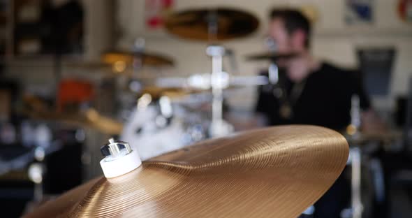 A professional drummer playing his musical instrument in a rock and roll garage band.