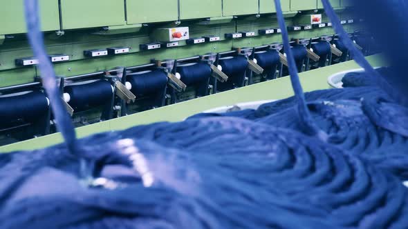 Textile Factory Machines are Sewing and Unreeling Yarn