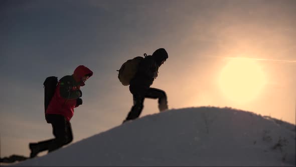Climbers Climb One After Another on a Snow-covered Hill. Team of Business People Go To Victory