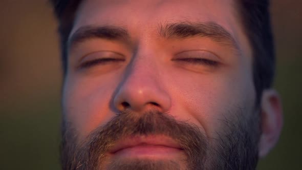 Caucasian Man Face Opens Eyes Dreaming Pink Lighting Closeup Slomo