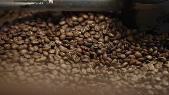 Coffee Production. Brown Beans Roasting In Machine Closeup