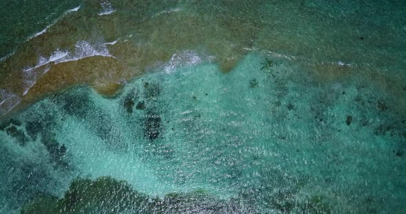 Natural overhead abstract view of a summer white paradise sand beach and aqua turquoise water backgr