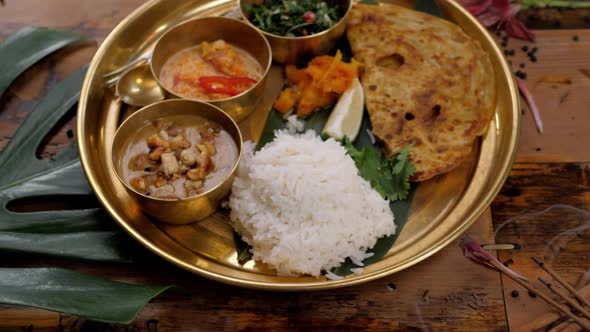 Spicy Chicken Tikka Masala in Bowl on Rustic Wooden Background. With Rice, Indian Naan Butter Bread