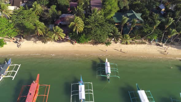 Top Drone View of a Traditional Philippine Boats on the Surface of the Azure Water in the Lagoon