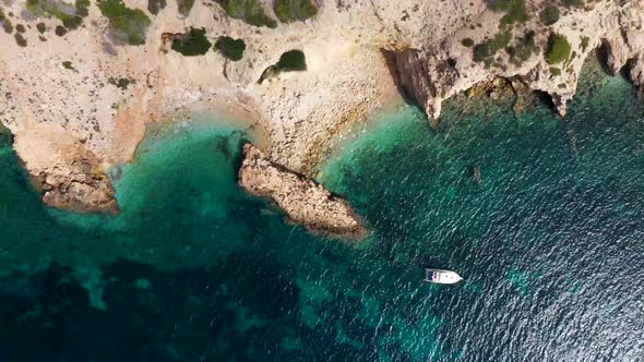 Straight down aerial footage of the Spanish island of Ibiza showing the beautiful cliff front