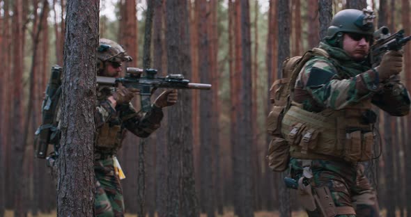 Fully Equipped Soldiers Wearing Camouflage Uniform Attacking Enemy Rifles in Firing Position