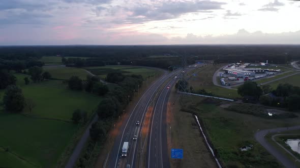 Aerial Slide Above European Freeway at Sunset with Car Traffic