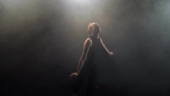 Feminine Actress During Dance on Smoky Black Stage