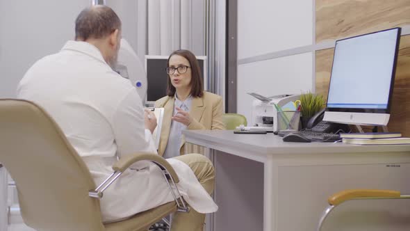 Woman Having Discussion with Doctor in Clinic