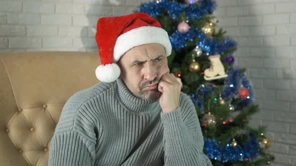 Man in Santa Hat with Sad Mood