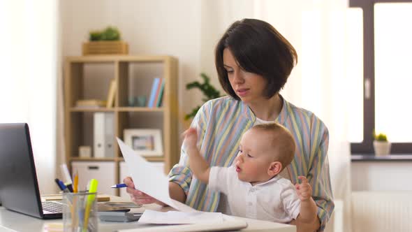 Working Mother with Baby Calling on Smartphone