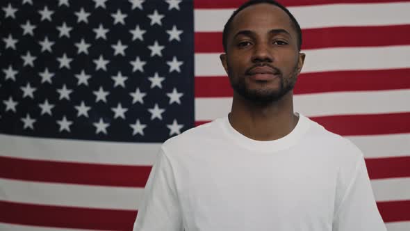 Portrait video of black man on American flag background. Shot with RED helium camera in 8K.