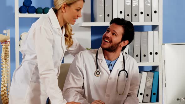Doctor and colleague interacting with each other