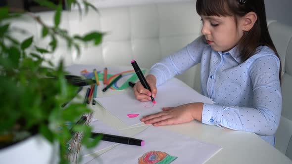 Child Draws Hearts on Paper with Pink Markers