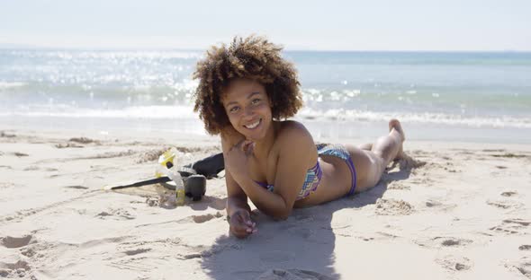 Female Lying on Beach with Flippers