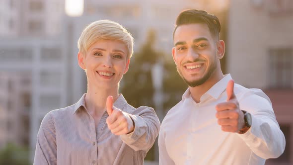 Multiethnic Two Business Partners Colleagues Caucasian Woman and Hispanic Man Put Thumbs Up Standing